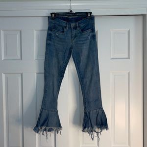 Blank NYC denim stretchy ankle jeans w/ flare distressed detail at the bottom.